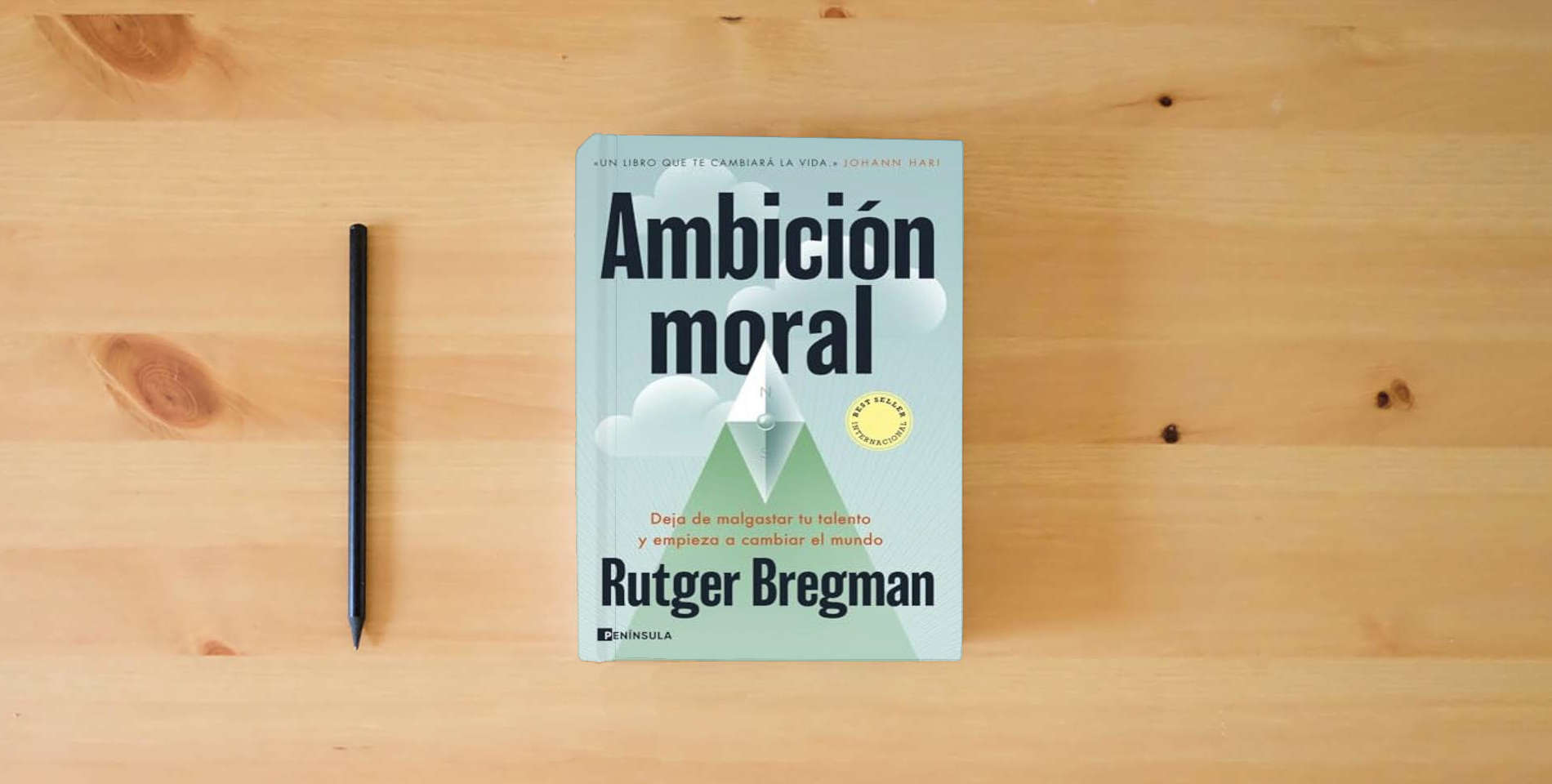 The book Ambición moral: Deja de malgastar tu talento y empieza a cambiar el mundo (PENINSULA) is on the table