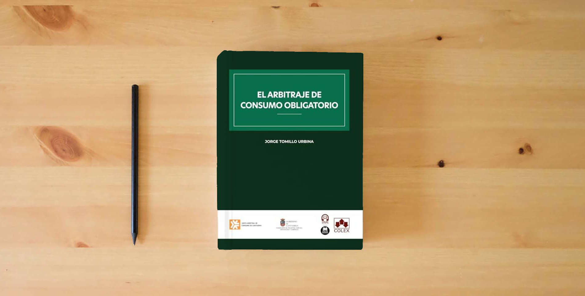 The book El arbitraje de consumo obligatorio (monografico) is on the table