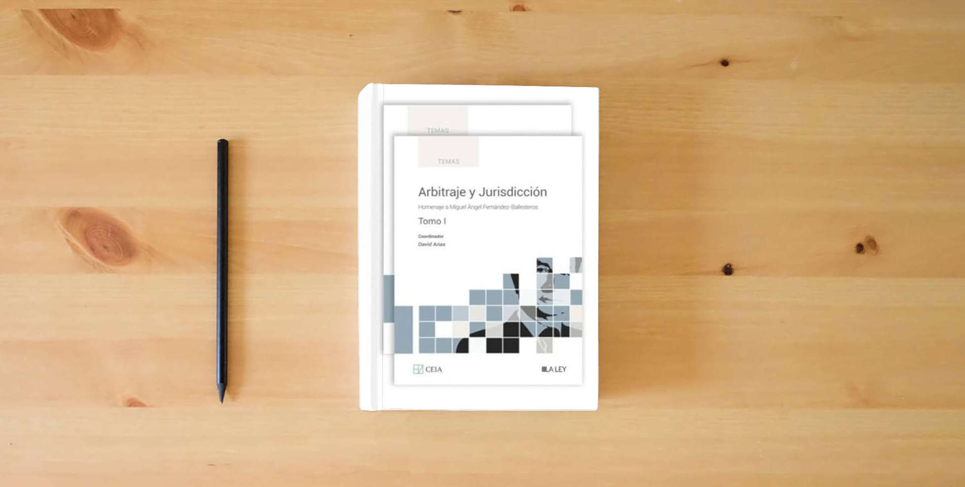 The book Arbitraje y Jurisdicción: Homenaje a Miguel Ángel Fernández-Ballesteros is on the table