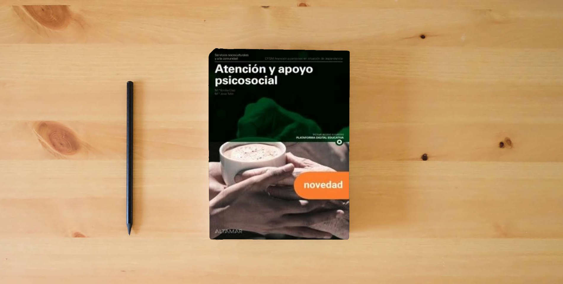 The book Atención y apoyo psicosocial. Nueva edición (CFGM ATENCIÓN A PERSONAS EN SITUACIÓN DE DEPENDENC) is on the table