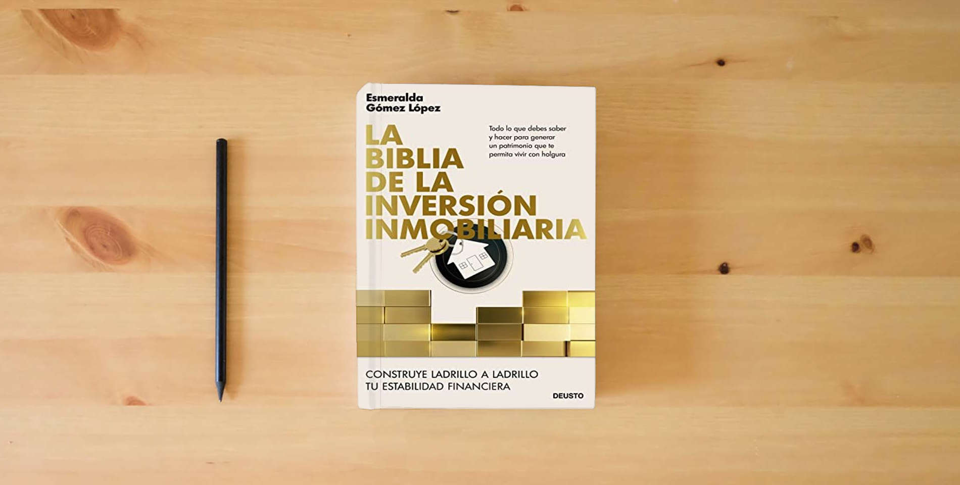 The book La biblia de la inversión inmobiliaria: Construye ladrillo a ladrillo tu estabilidad financiera (Deusto) is on the table