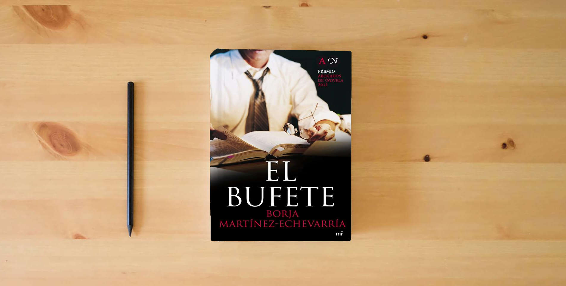 The book El bufete (MR Narrativa) is on the table