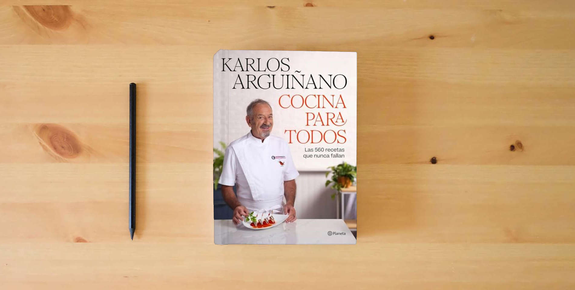 The book Cocina para todos: Las 560 recetas que nunca fallan (Planeta Cocina) is on the table