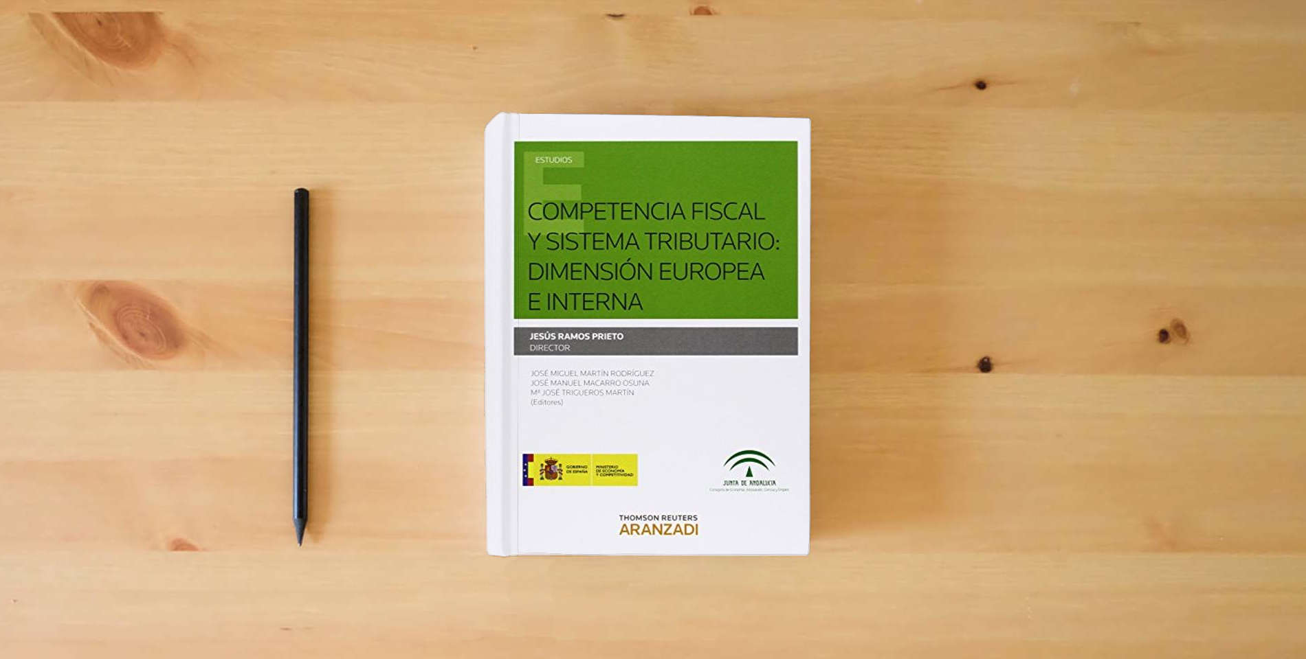 The book Competencia Fiscal y Sistema tributario: Dimensión Europea e interna (Monografía) is on the table