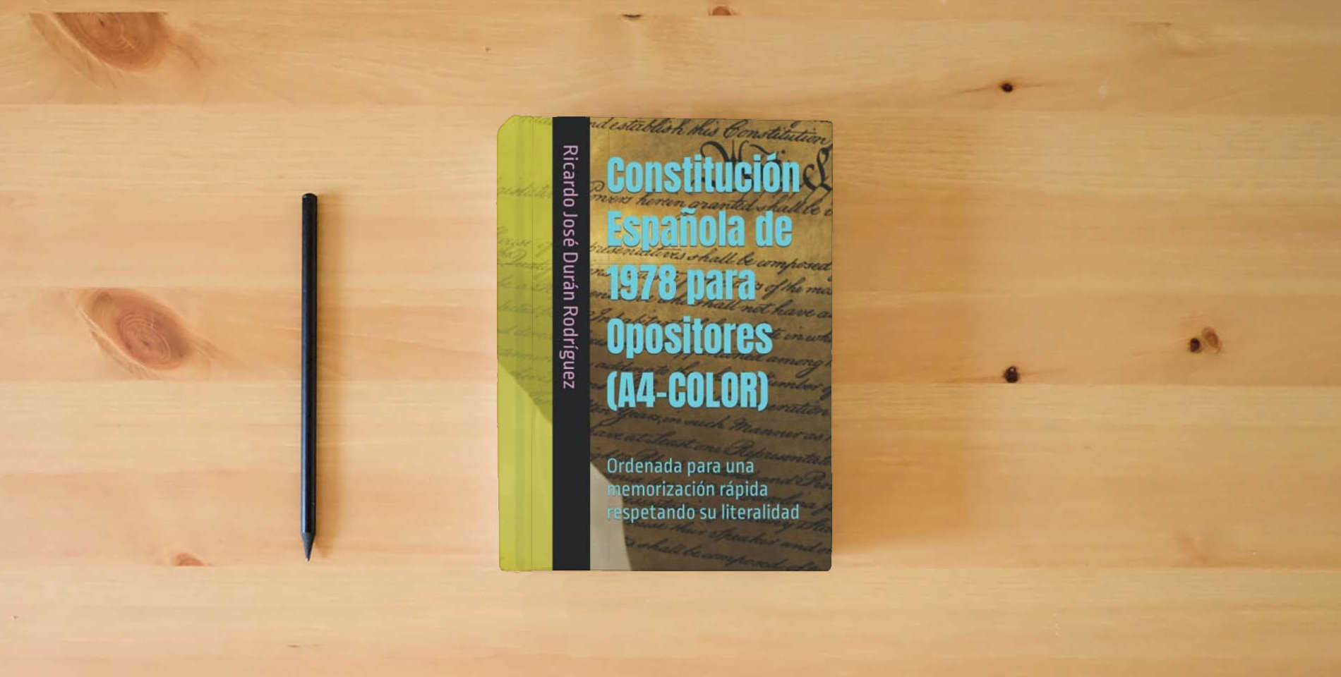 The book Constitución Española de 1978 para Opositores (A4-COLOR): Ordenada para una memorización rápida respetando su literalidad is on the table