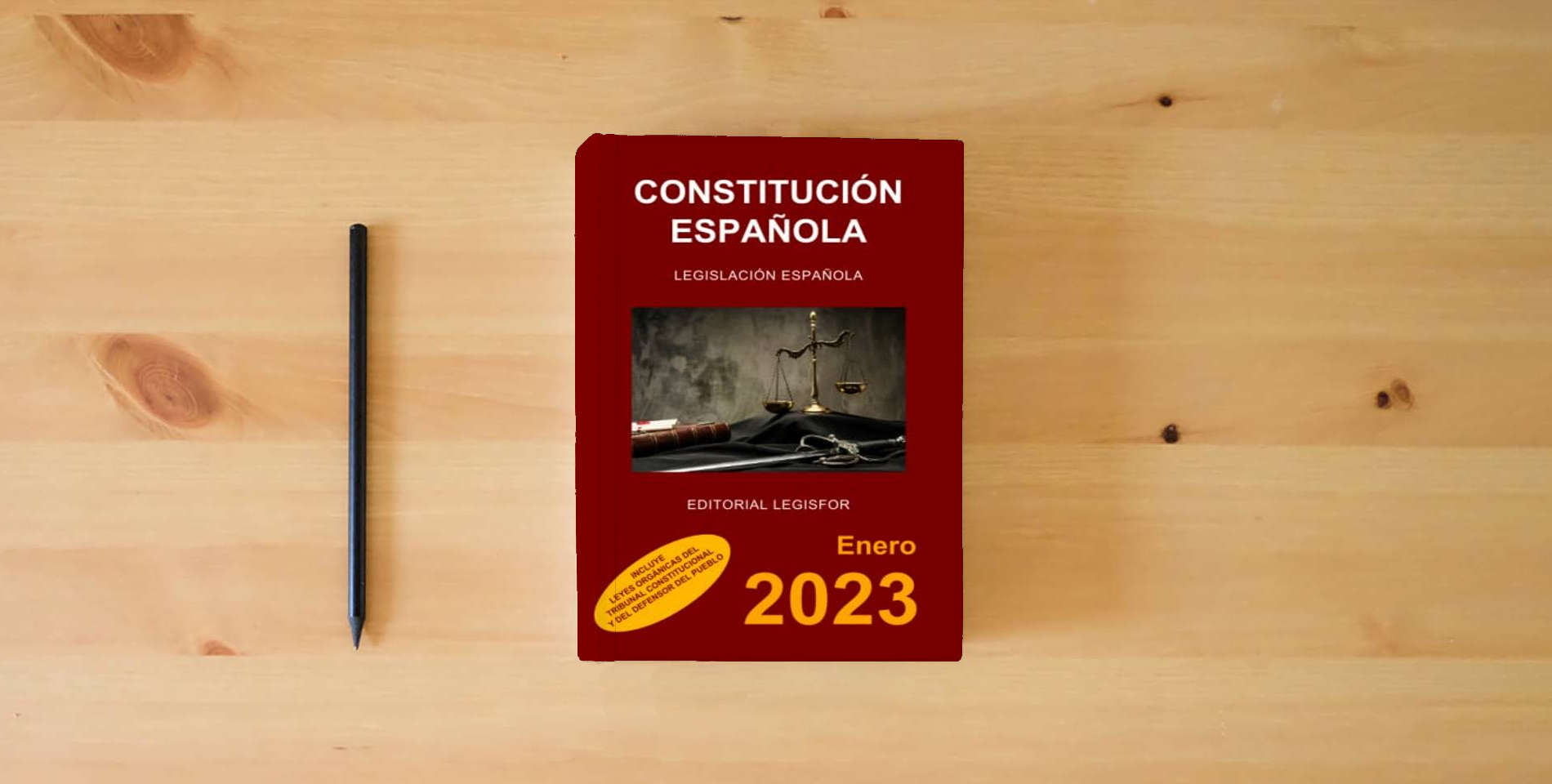 The book Constitución Española: incluye Leyes Orgánicas del Tribunal Constitucional y del Defensor del Pueblo is on the table