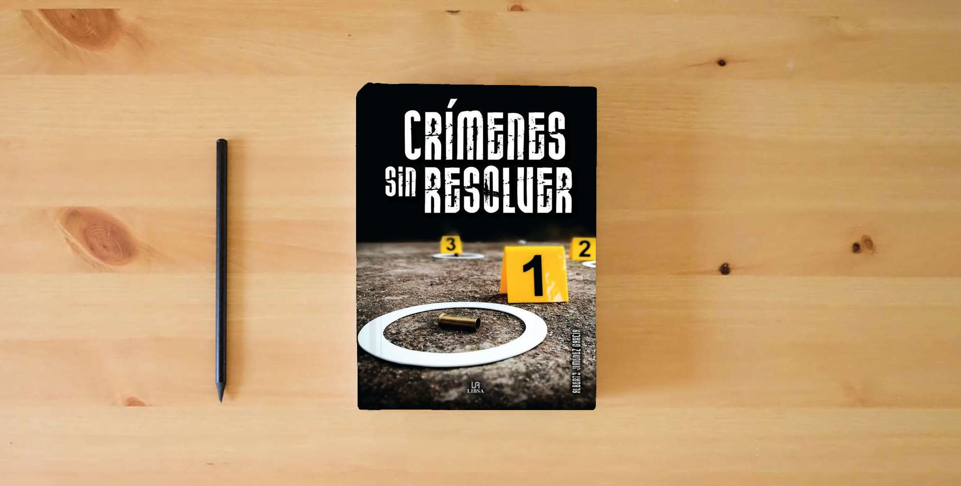 The book Crímenes sin Resolver: 2 (Criminología) is on the table