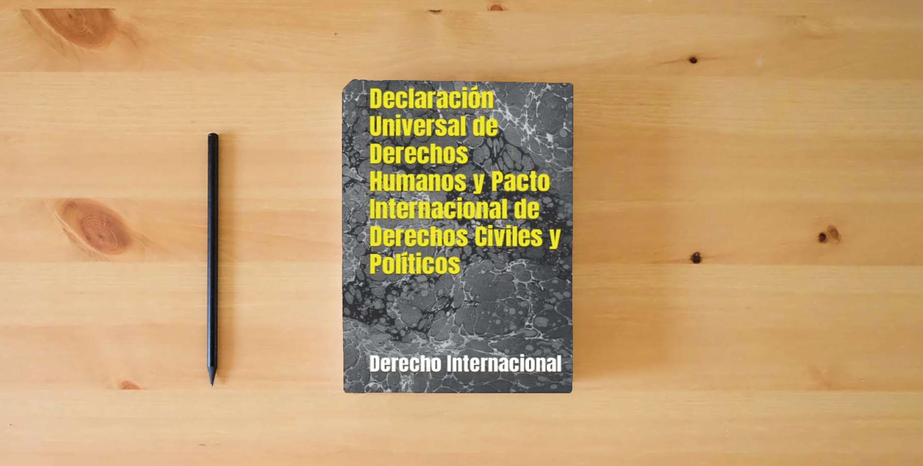 The book Declaración Universal de Derechos Humanos y Pacto Internacional de Derechos Civiles y Políticos is on the table