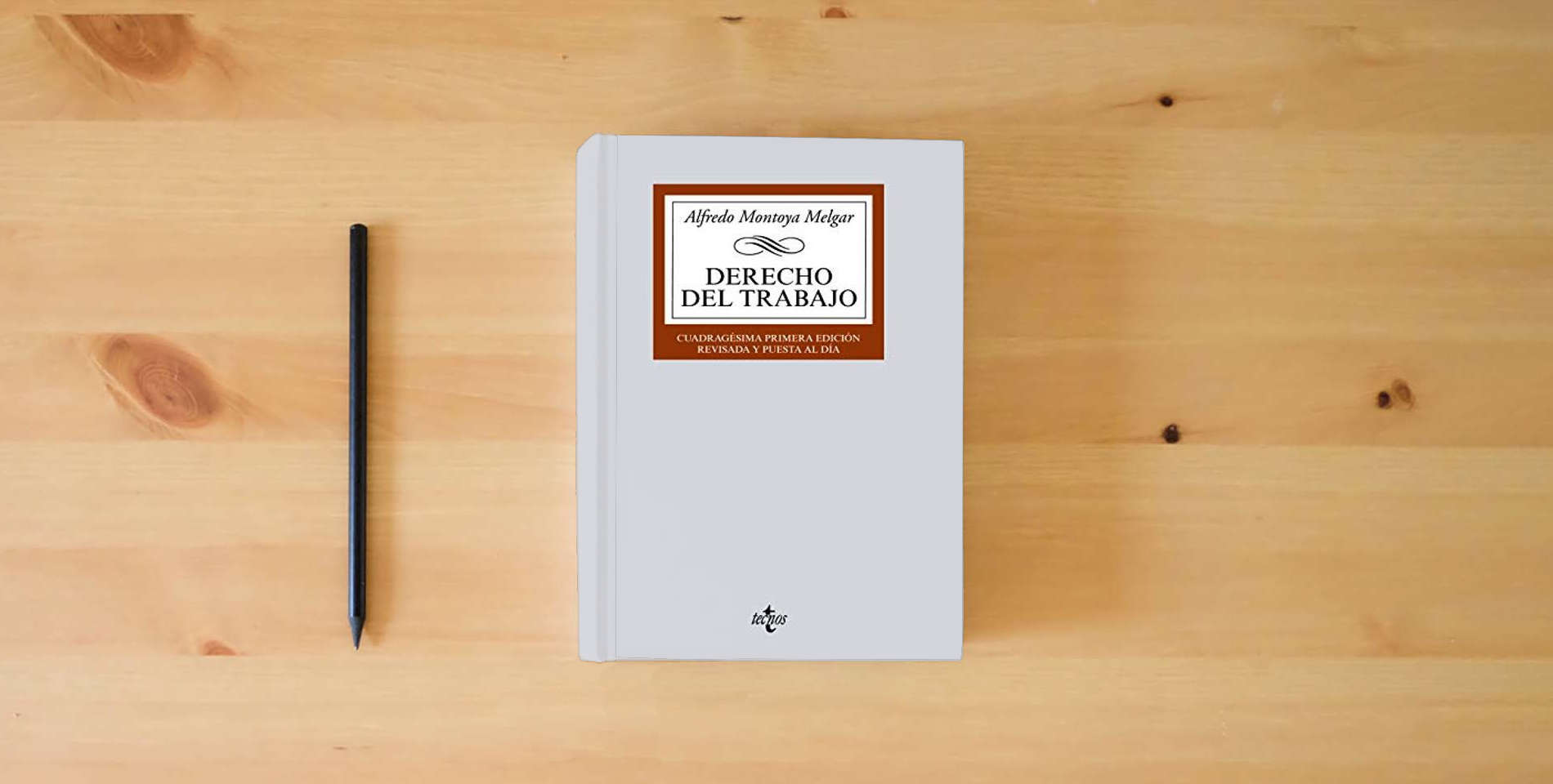 The book Derecho del Trabajo (Derecho - Biblioteca Universitaria de Editorial Tecnos) is on the table