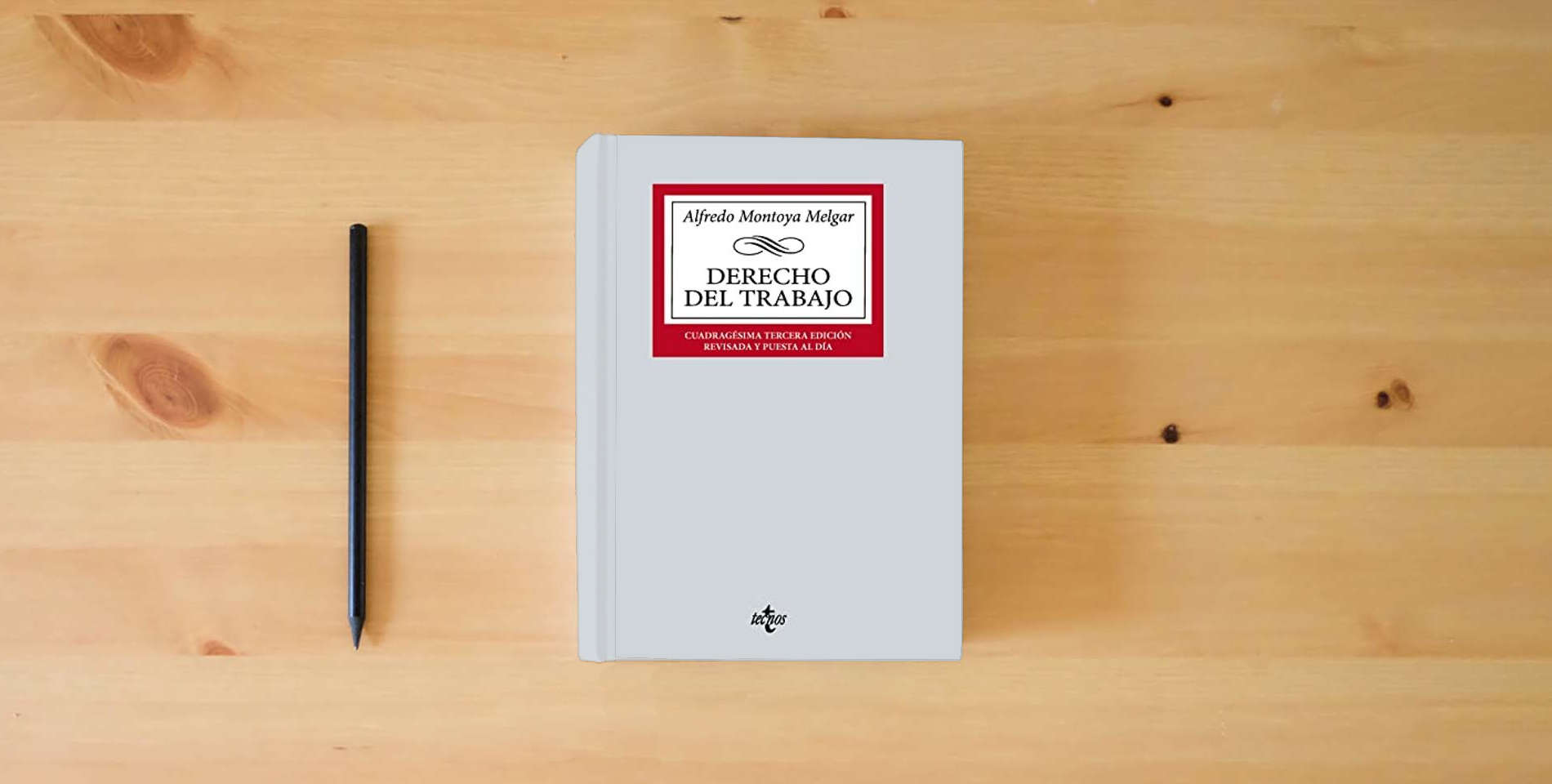 The book Derecho del Trabajo (Derecho - Biblioteca Universitaria de Editorial Tecnos) is on the table