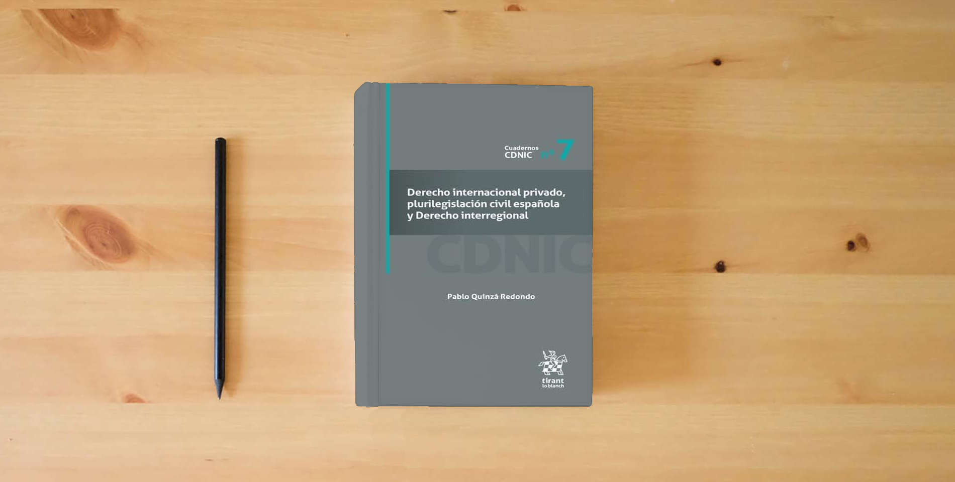 The book Derecho Internacional Privado, Plurilegislación Civil Española y Derecho Interregional Nº 7 (Cuadernos CDNIC) is on the table