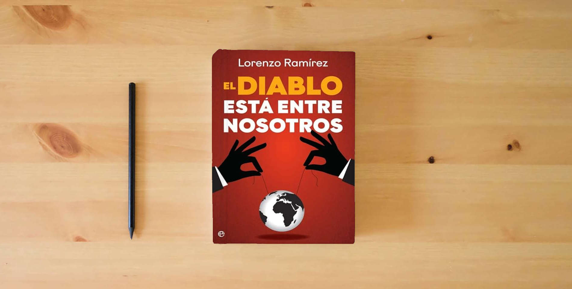 The book El diablo está entre nosotros: Los agentes del caos del nuevo orden mundial (Actualidad) is on the table