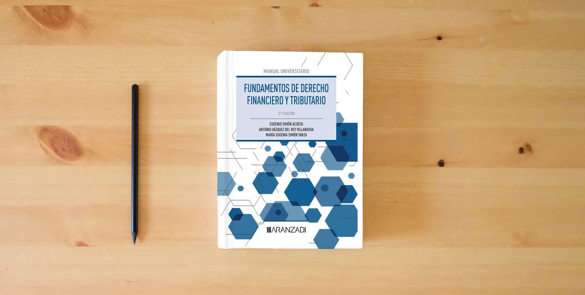 The book Fundamentos de Derecho Financiero y Tributario (Manuales) is on the table