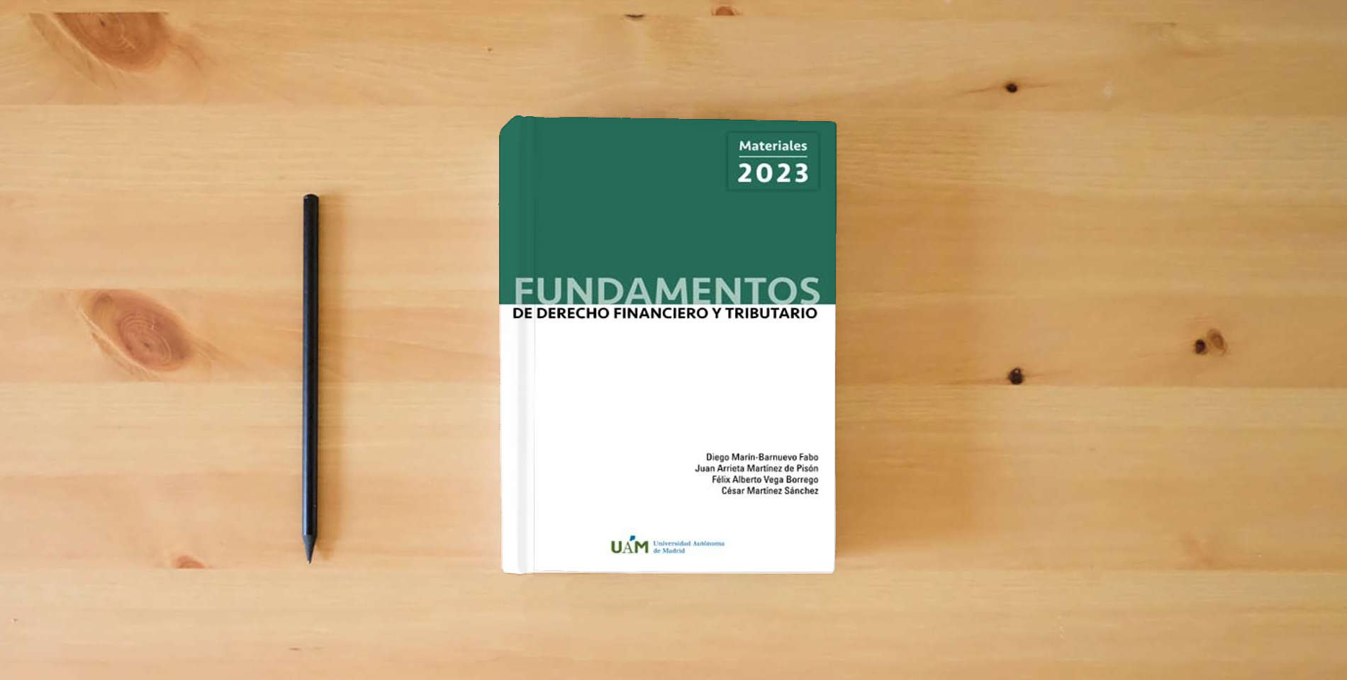 The book Fundamentos de Derecho Financiero y Tributario. Materiales 2023. is on the table