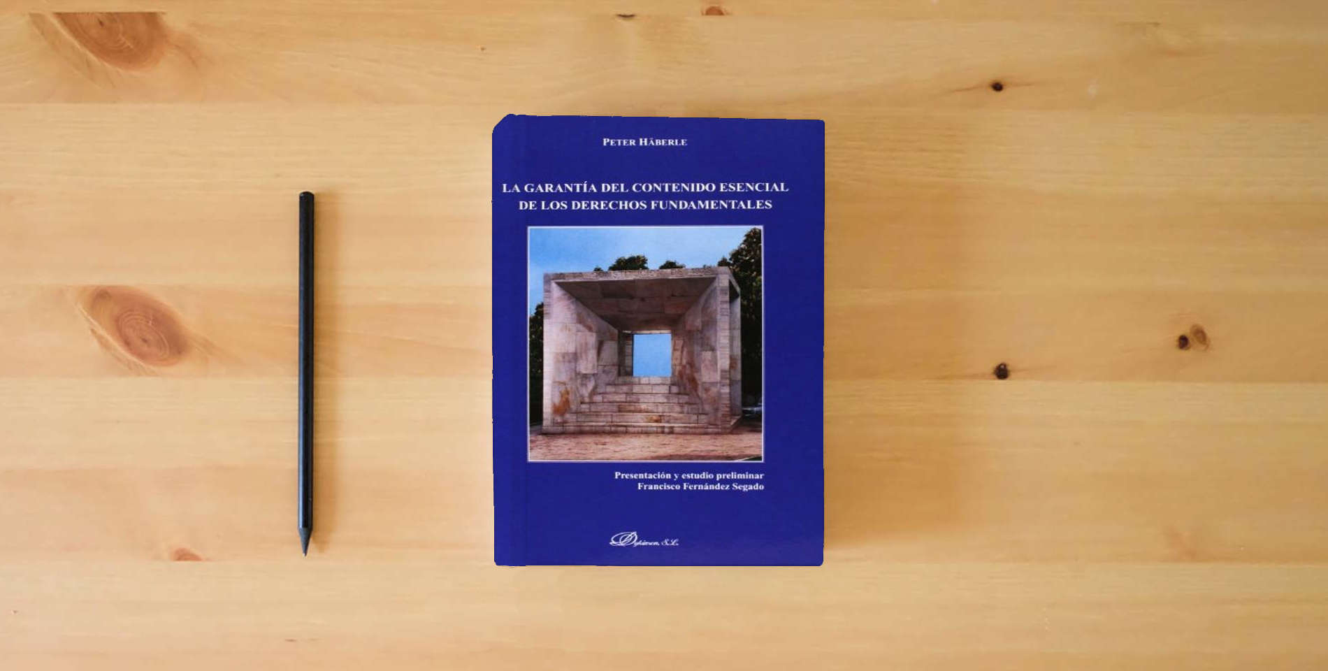 The book La Garantía Del Contenido Esencial De Los Derechos Fundamentales is on the table