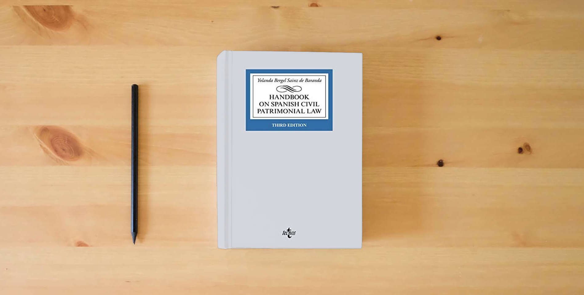 The book Handbook on Spanish Civil Patrimonial Law (Derecho - Biblioteca Universitaria de Editorial Tecnos) is on the table