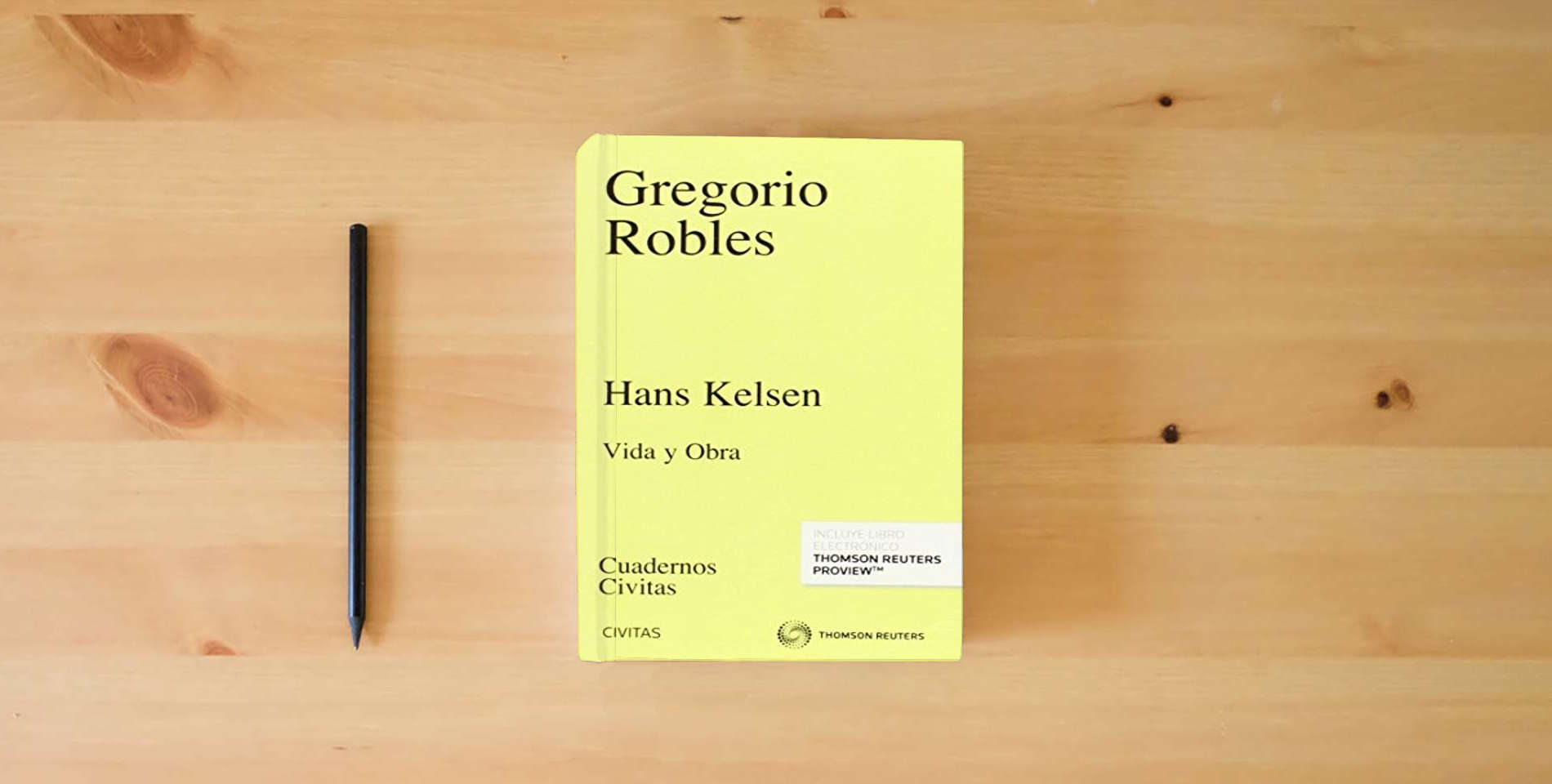 The book Hans Kelsen: Vida y Obra (Cuadernos) is on the table