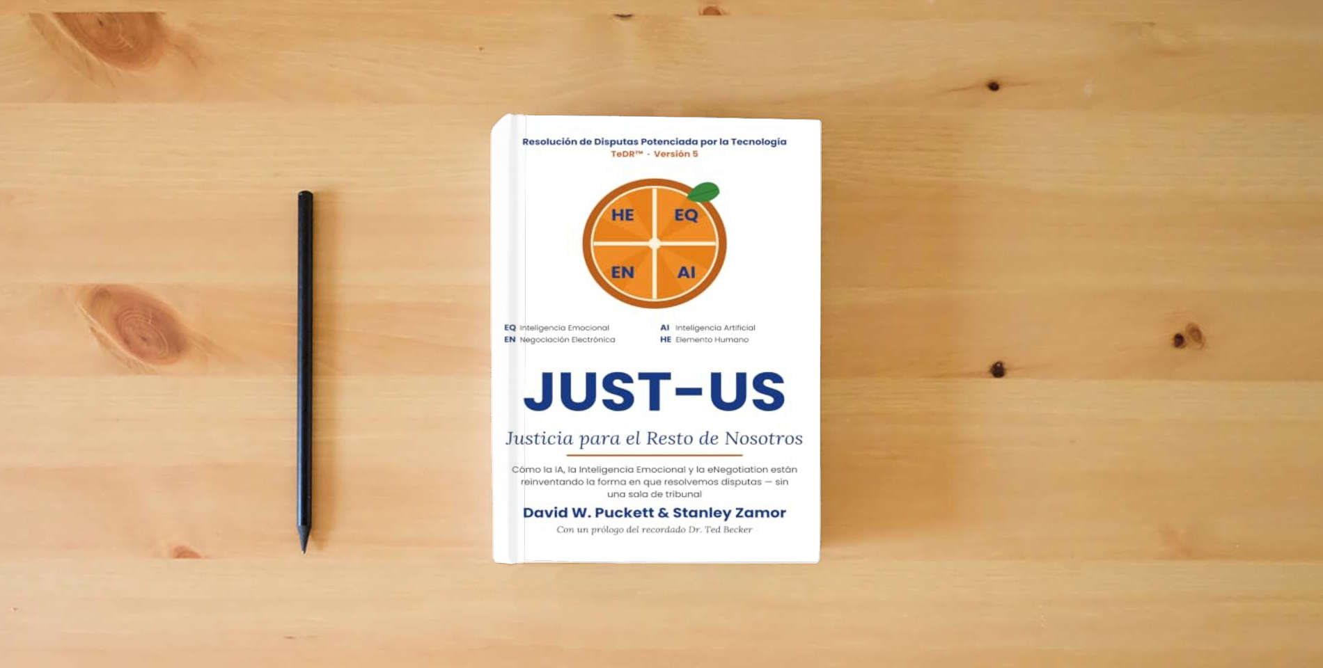 The book Just-US: Justicia para el Resto de Nosotros: Cómo la IA y la Inteligencia Emocional están reinventando la resolución de disputas is on the table