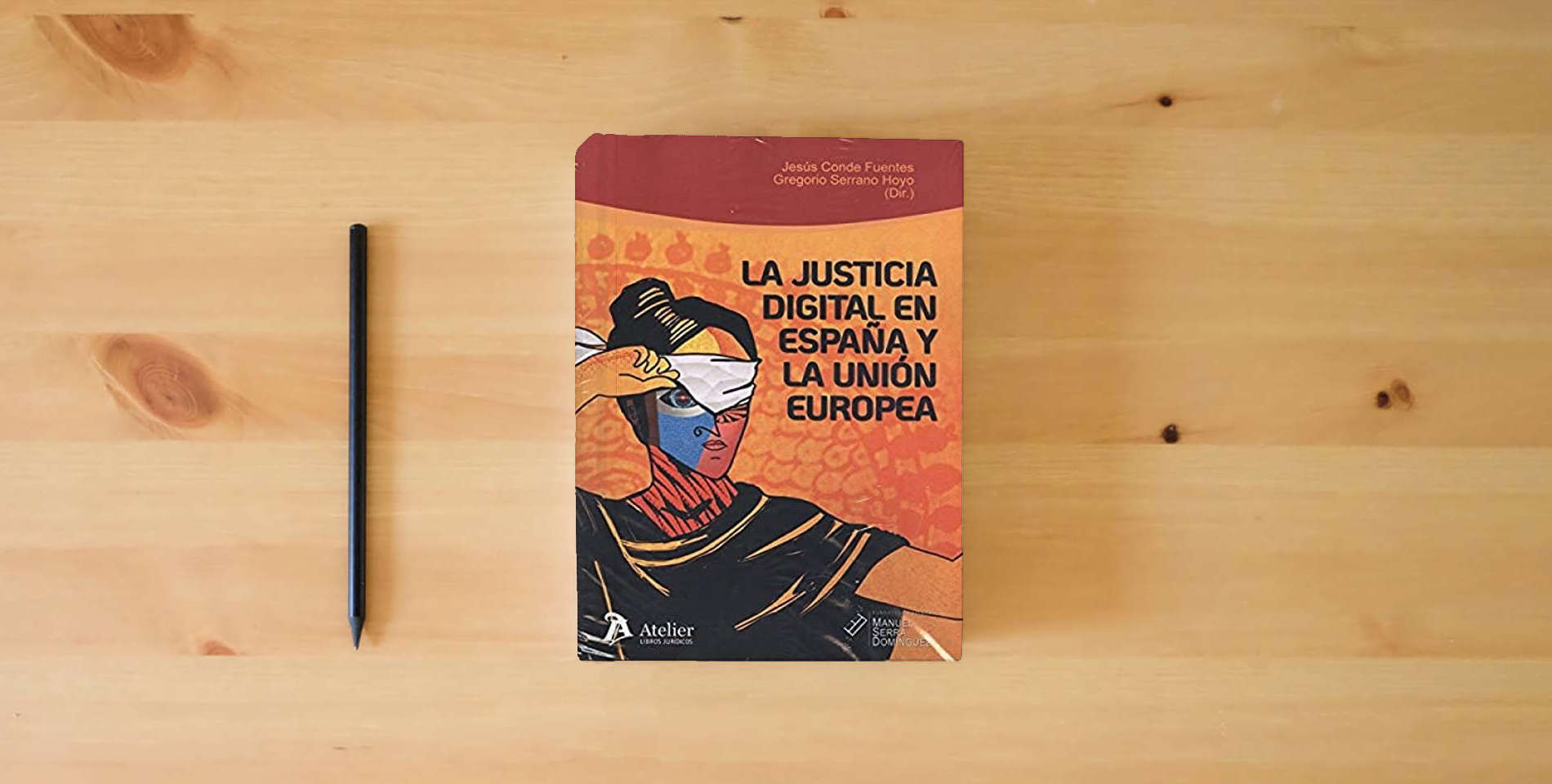 The book La justicia digital en España y la Unión Europea:: situación actual y perspectivas de futuro (ATELIER) is on the table
