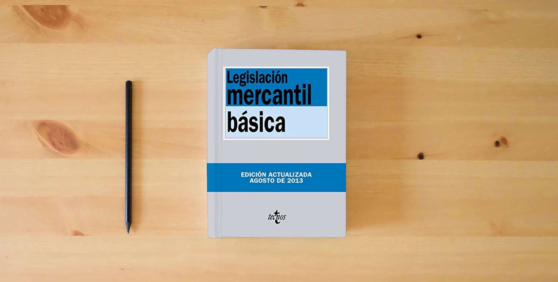 The book Legislación mercantil básica (Derecho - Biblioteca de Textos Legales) is on the table