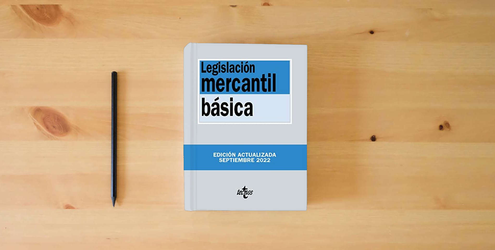 The book Legislación mercantil básica (Derecho - Biblioteca de Textos Legales) is on the table