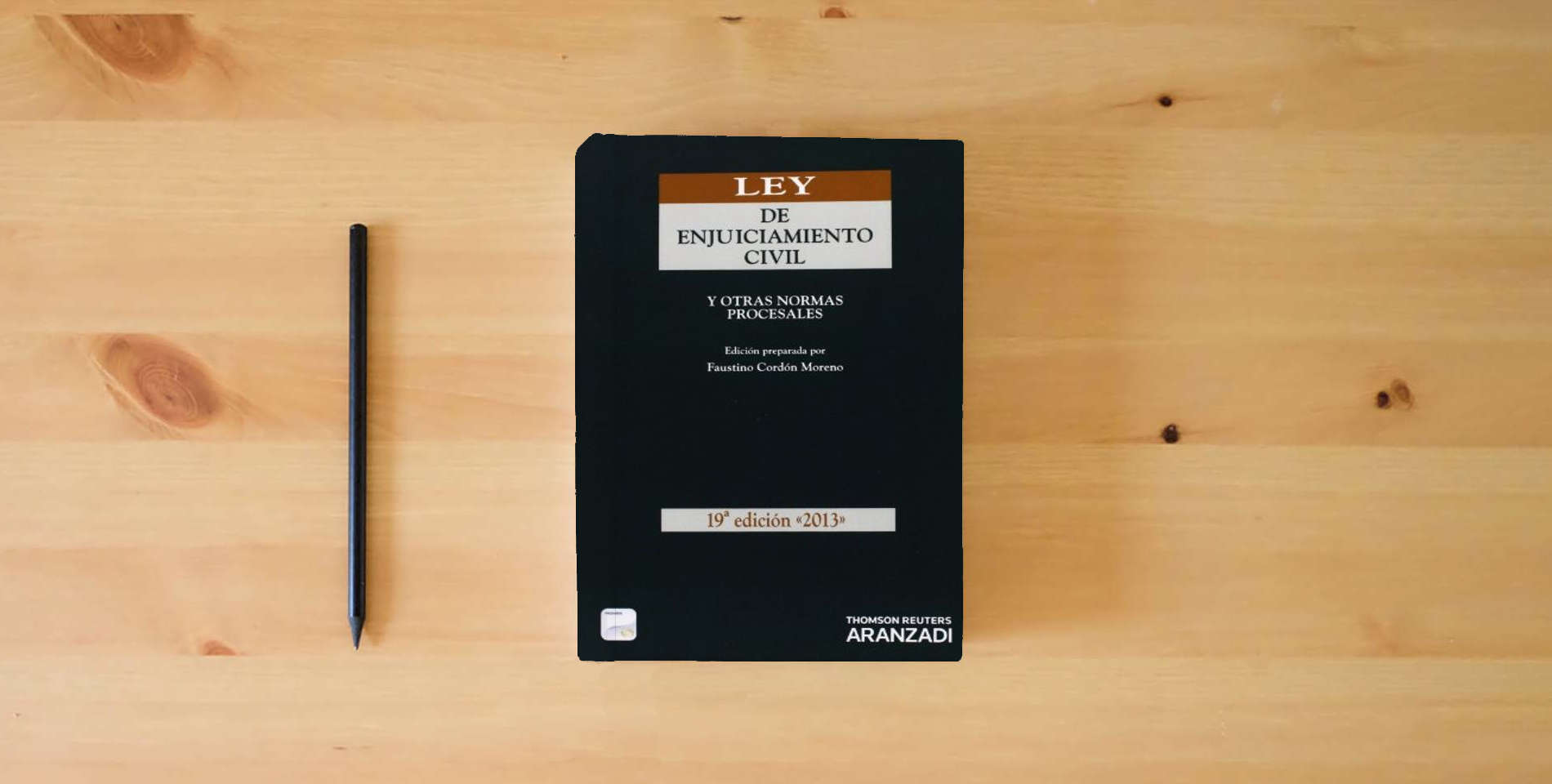 The book Ley de Enjuiciamiento Civil (Papel + e-book) - y otras normas procesales: 3 (Código Básico) is on the table
