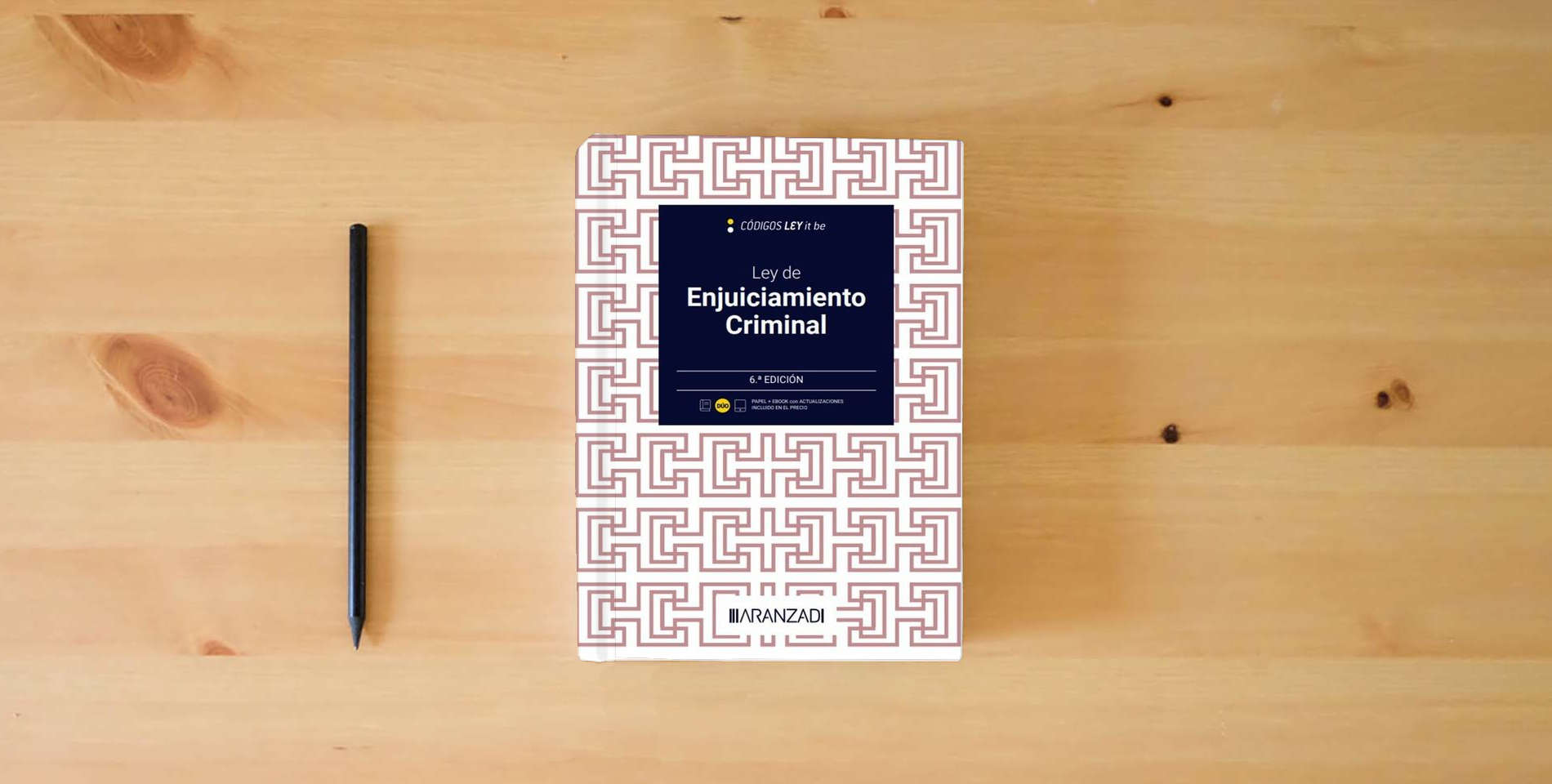 The book Ley de Enjuiciamiento Criminal (LeyItBe) (Código Básico) is on the table