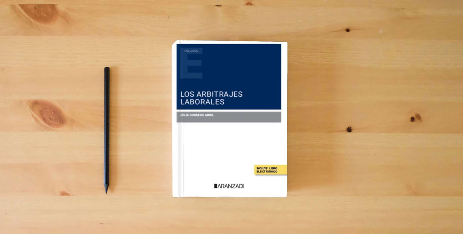 The book Los Arbitrajes Laborales (Estudios) is on the table
