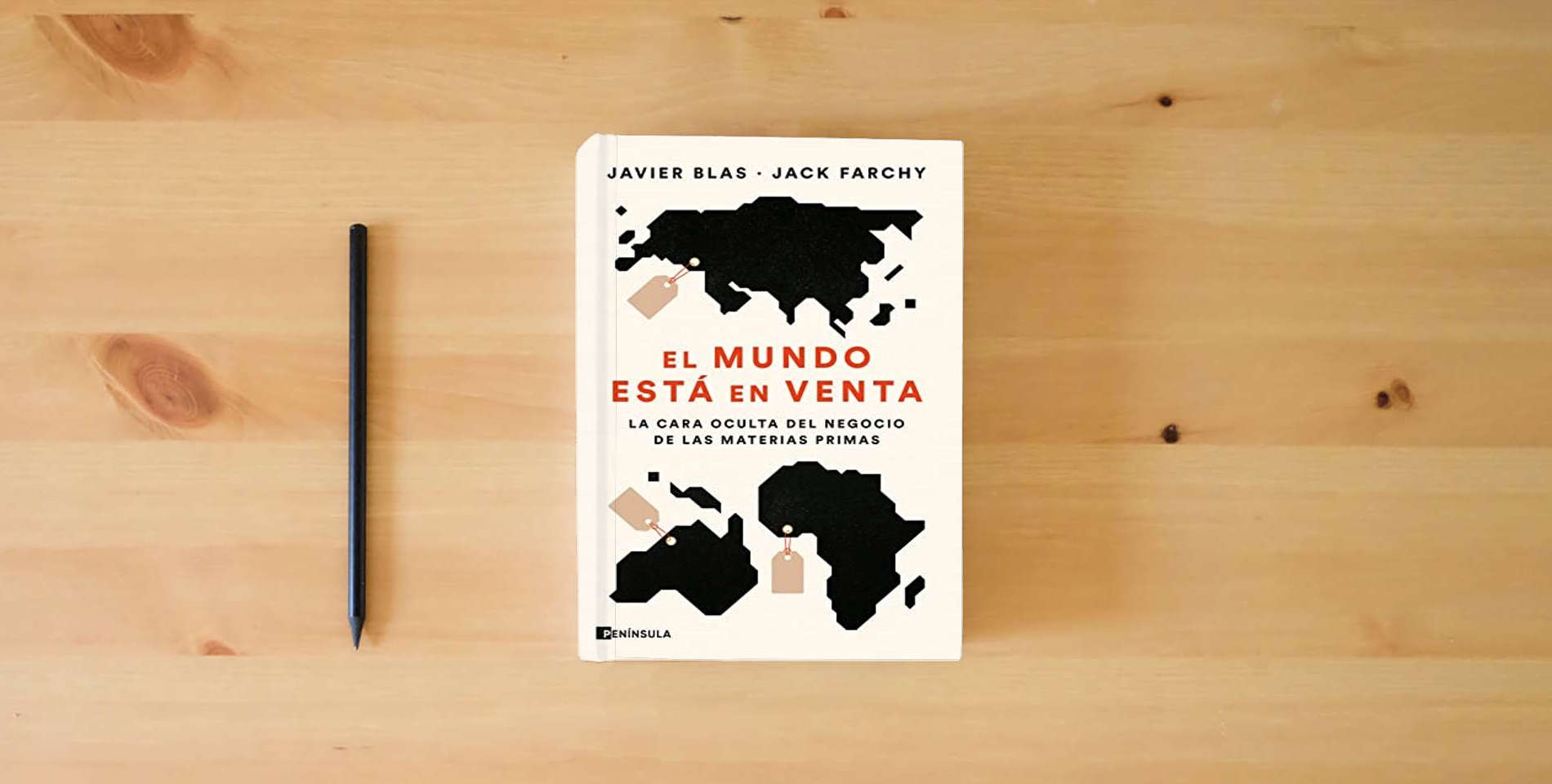 The book El mundo está en venta: La cara oculta del negocio de las materias primas (PENINSULA) is on the table