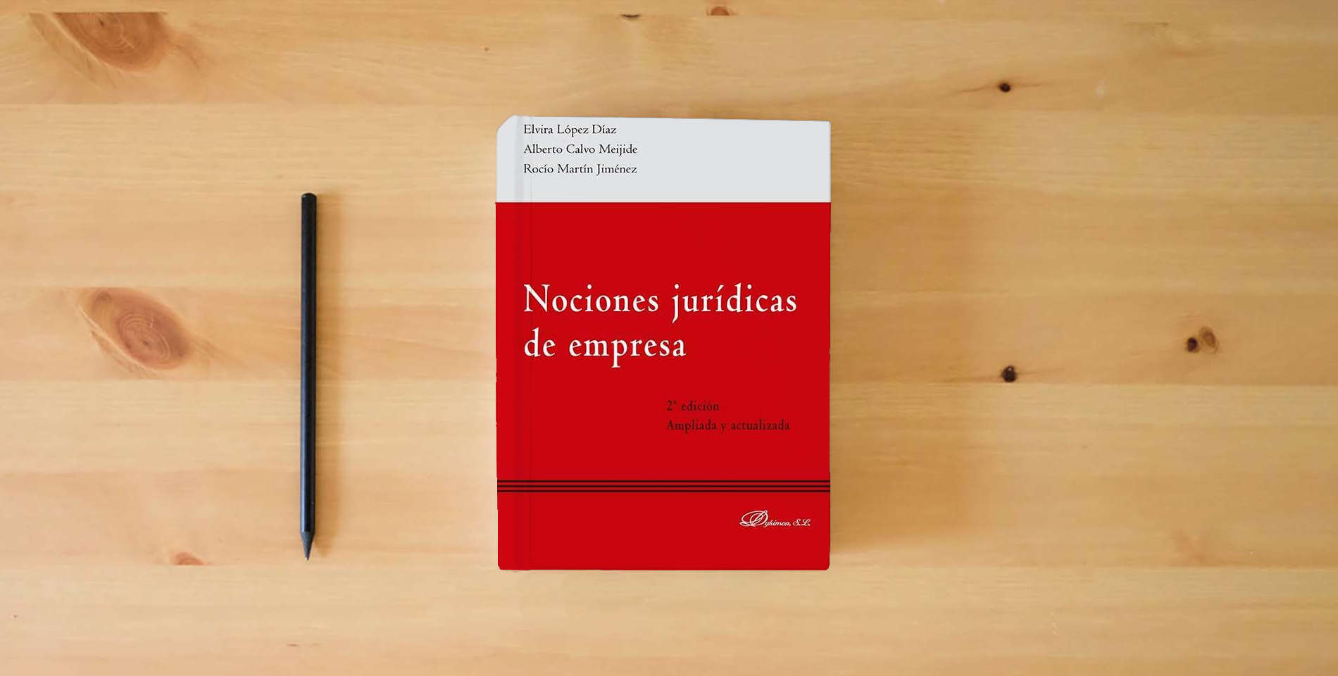 The book Nociones jurídicas de empresa (SIN COLECCION) is on the table