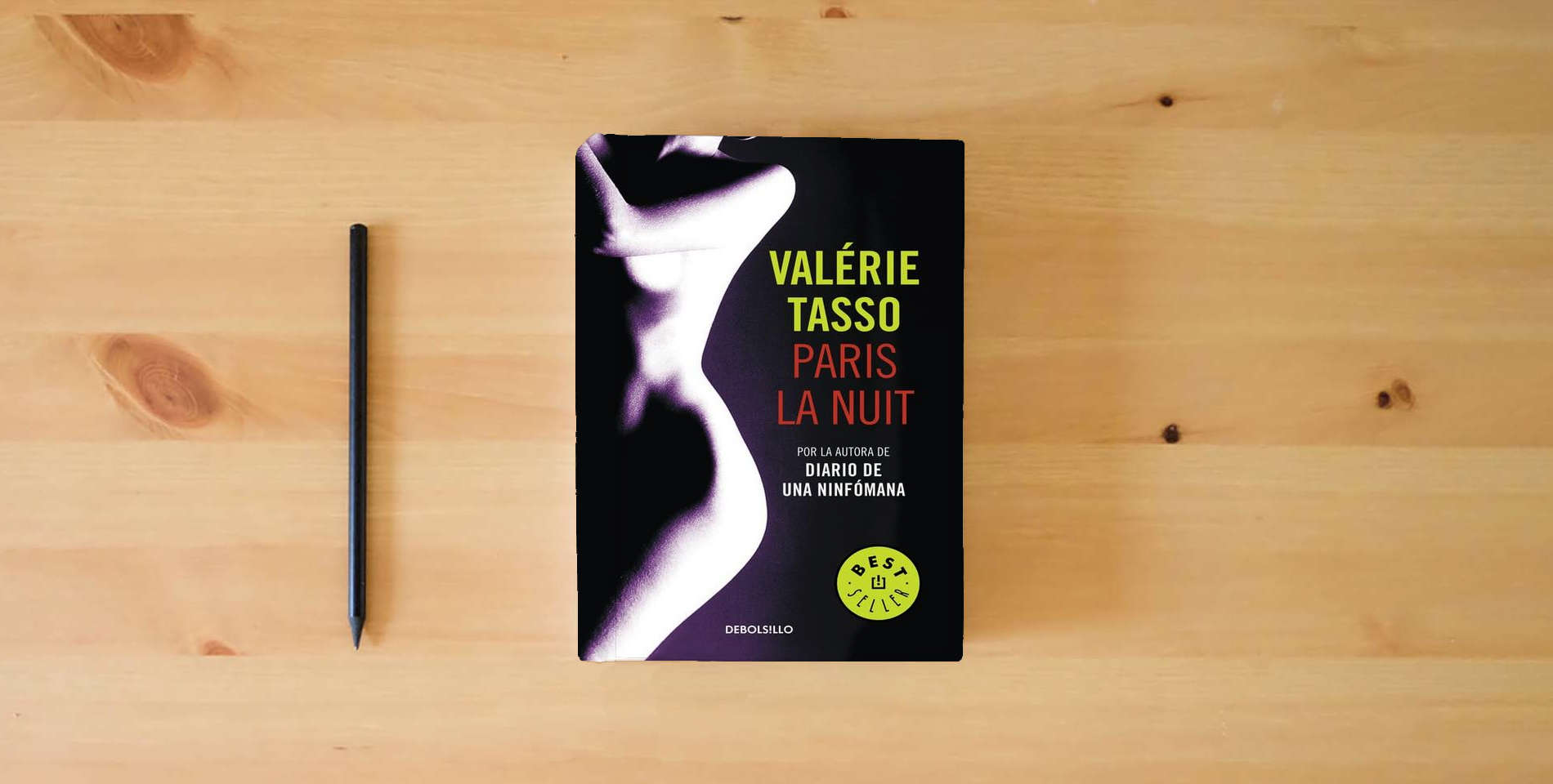 The book Paris la nuit (Best Seller) is on the table