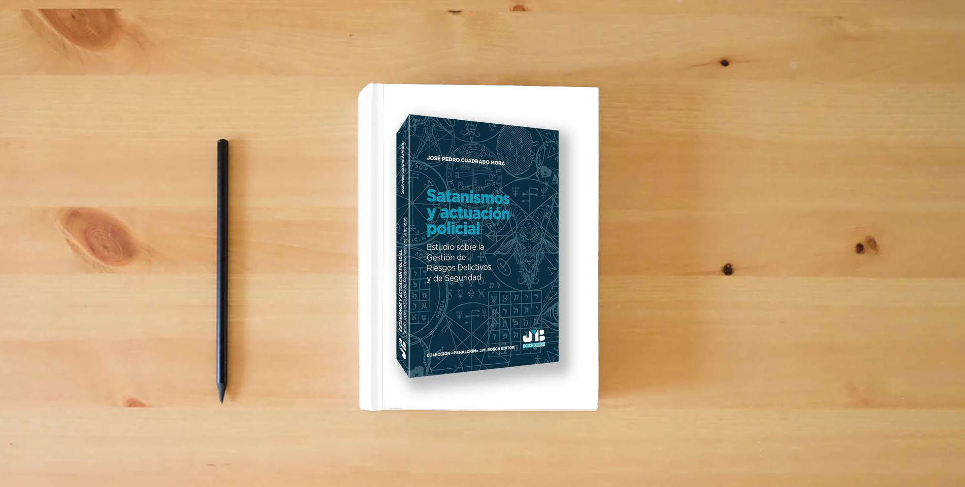 The book Satanismos y actuación policial: Estudio sobre la gestión de riesgos delictivos y de seguridad: 38 (Colección "Penalcrim" J.M. Bosch Editor) is on the table