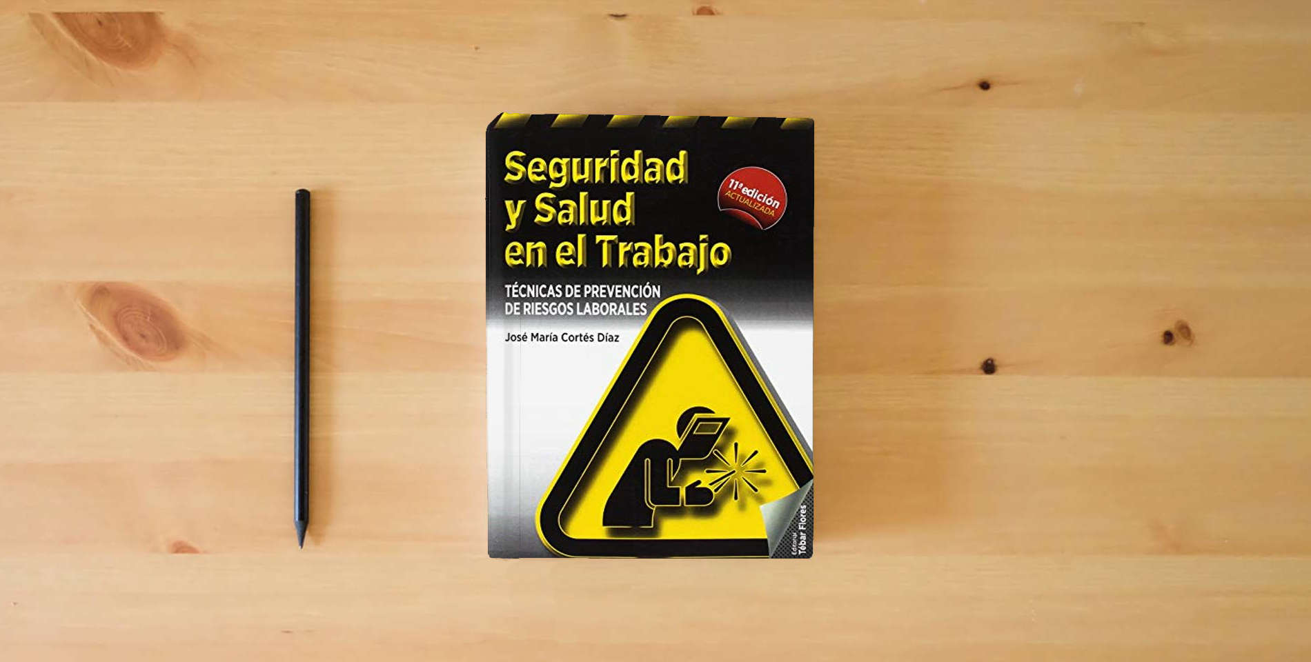 The book Seguridad y salud en el trabajo (11ª ED): Técnicas de prevención de riesgos laborales (SIN COLECCION) is on the table