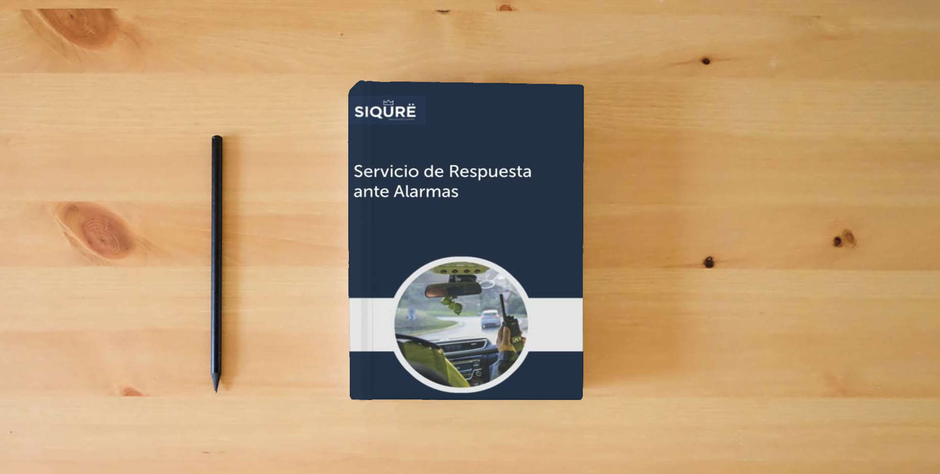 The book Servicio de Respuesta ante Alarmas (Security) is on the table