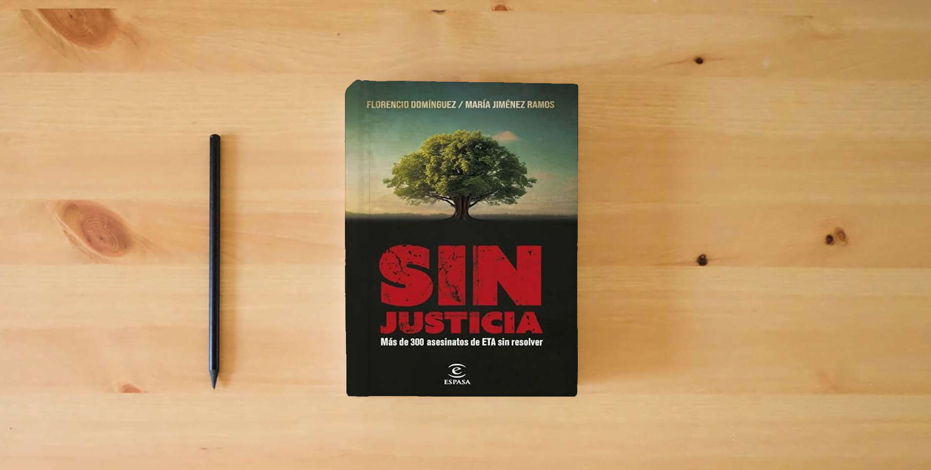 The book Sin justicia: Más de 300 asesinatos de ETA sin resolver (NO FICCIÓN) is on the table