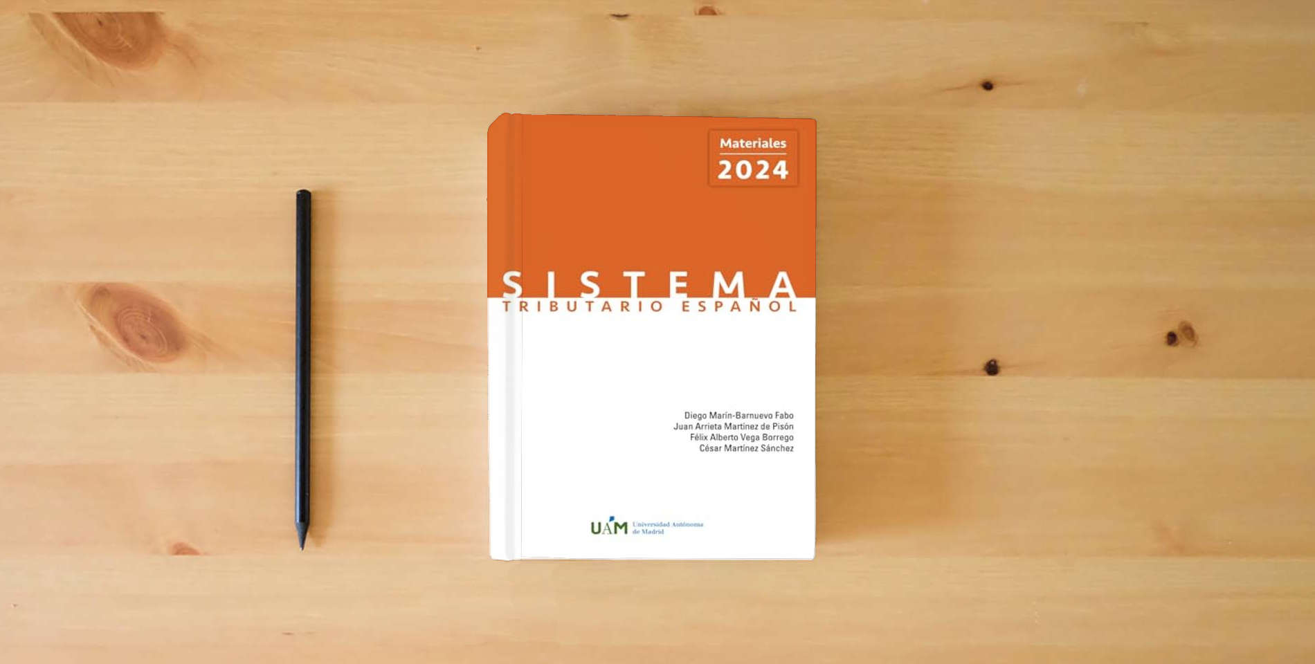 The book Sistema Tributario Español. Materiales 2024 is on the table