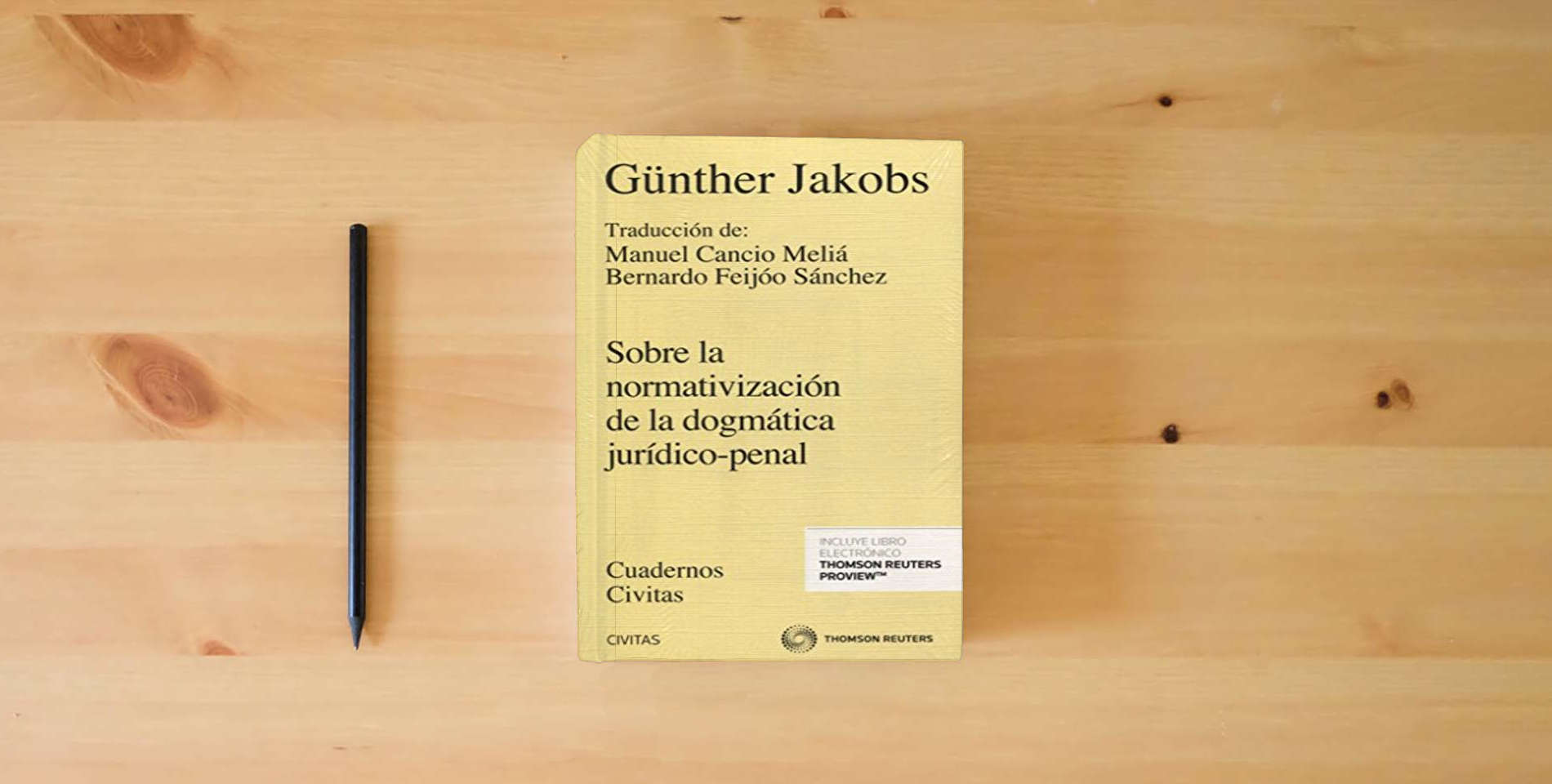 The book Sobre la Normativización de la Dogmática Jurídico-Penal (Cuadernos) is on the table
