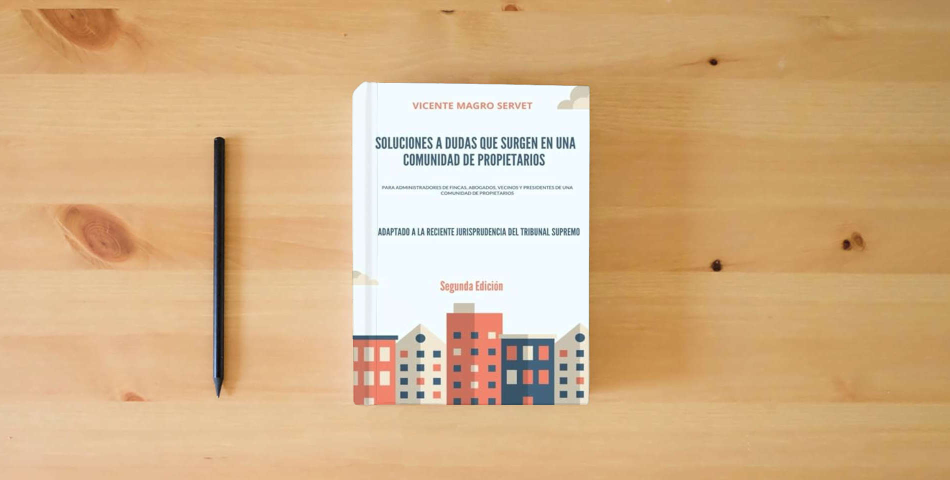 The book SOLUCIONES A DUDAS QUE SURGEN EN UNA COMUNIDAD DE PROPIETARIOS: 2a Edición is on the table