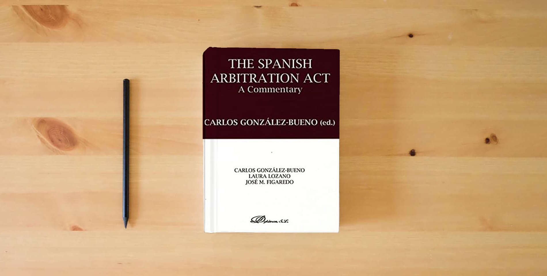The book The Spanish arbitration act. A commentary (SIN COLECCION) is on the table