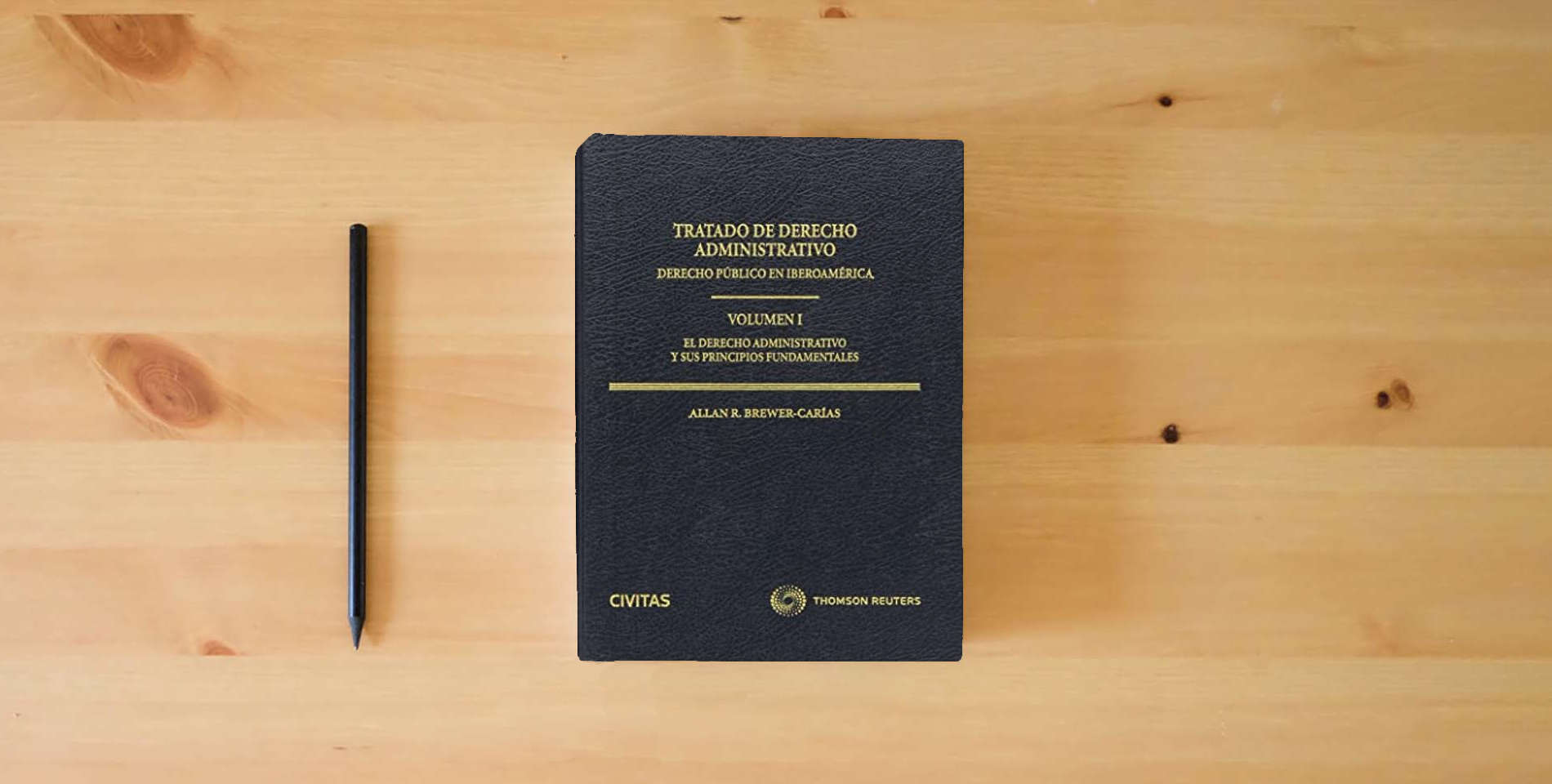 The book Tratado de Derecho Administrativo (Monografía) is on the table