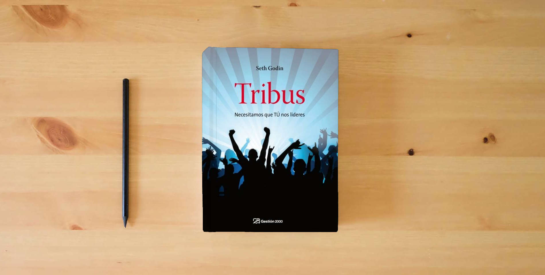 The book Tribus: Necesitamos que TÚ nos lideres (MARKETING Y VENTAS) is on the table