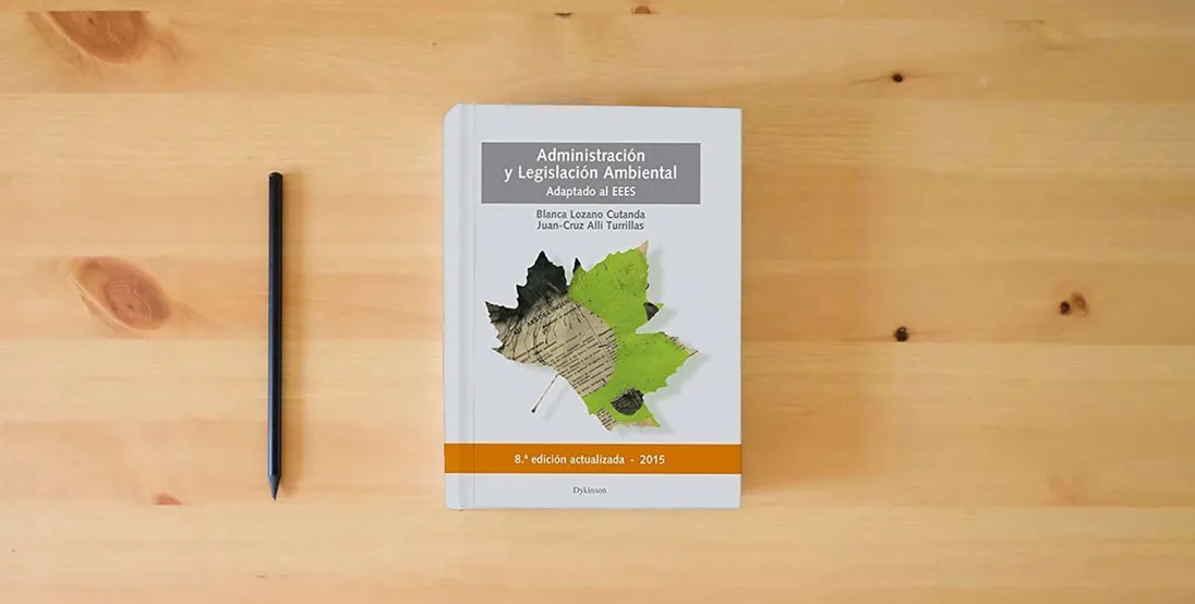The book Administración y legislación ambiental. Actualizado y Adaptado al EEES (SIN COLECCION)} is on the table
