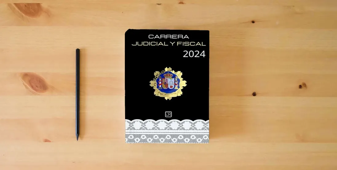 The book Agenda para Opositores de Carrera Judicial y Fiscal 2024 (OpoAgendas)} is on the table