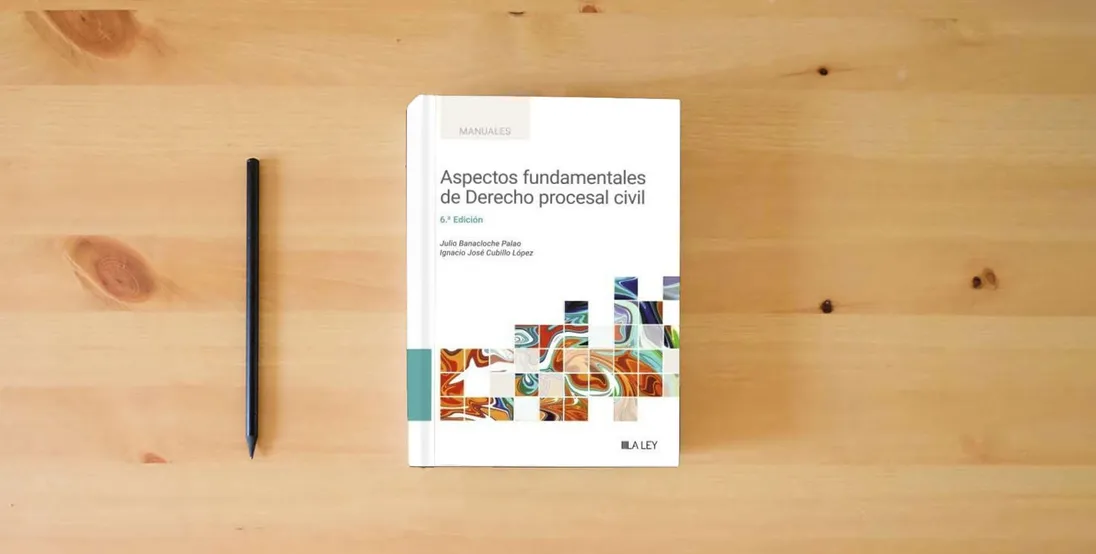 The book Aspectos fundamentales de derecho procesal civil (Manuales Universitarios)} is on the table