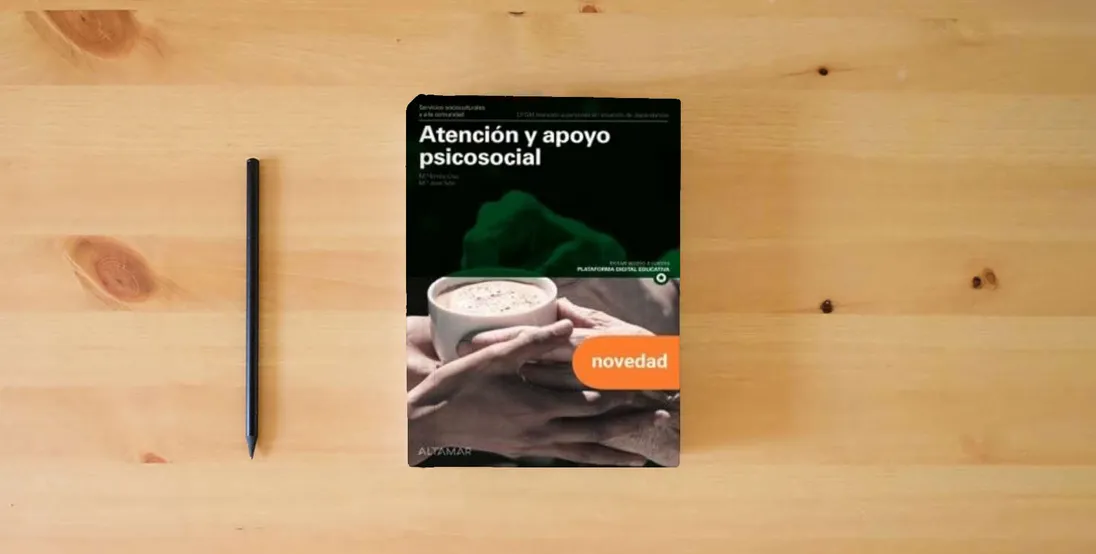 The book Atención y apoyo psicosocial. Nueva edición (CFGM ATENCIÓN A PERSONAS EN SITUACIÓN DE DEPENDENC)} is on the table