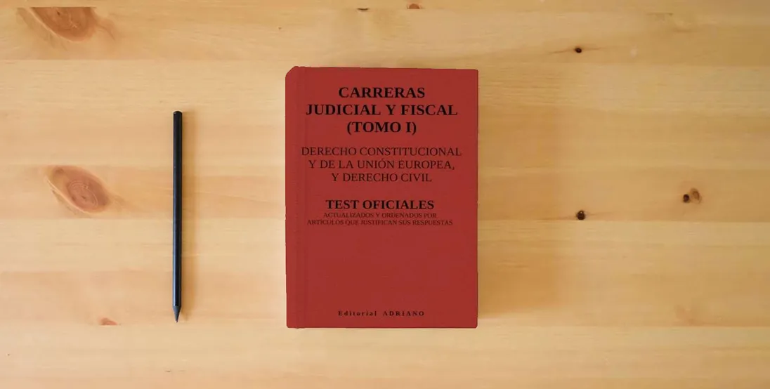 The book Carreras Judicial y Fiscal (Tomo I): Test oficiales actualizados y ordenados por artículos que justifican sus respuestas} is on the table