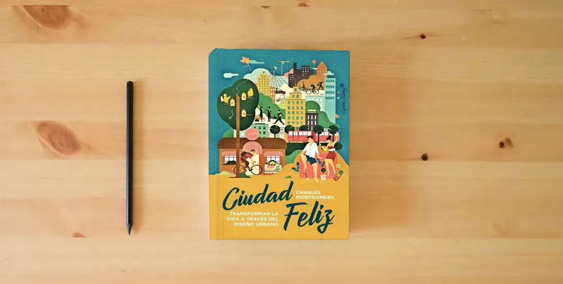The book Ciudad Feliz: Transformar la vida a través del diseño urbano (ENSAYO)} is on the table