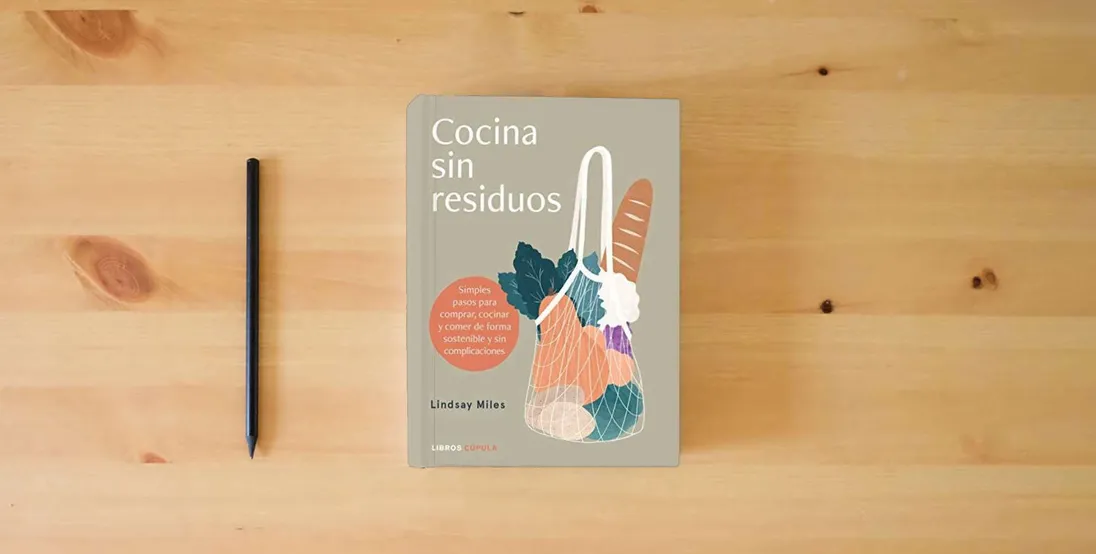 The book Cocina sin residuos: Simples pasos para comprar, cocinar y comer de forma sostenible y sin complicaciones} is on the table