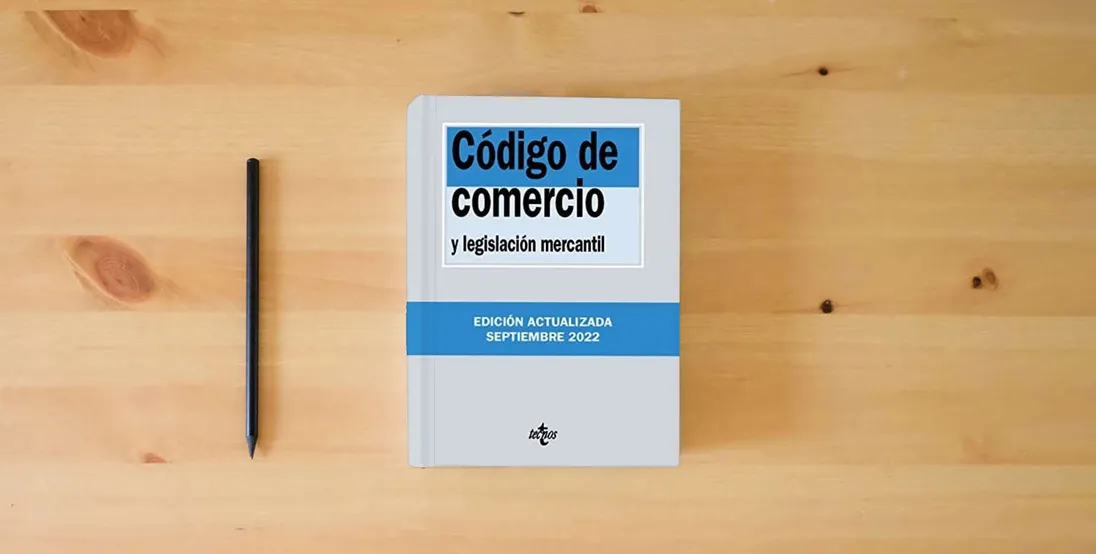 The book Código de Comercio: y legislación mercantil (Derecho - Biblioteca de Textos Legales)} is on the table