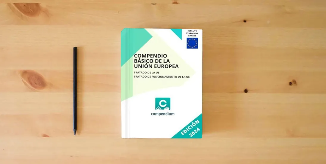 The book COMPENDIO BÁSICO DE LA UNIÓN EUROPEA: Tratado de la UE - Tratado de Funcionamiento de la UE} is on the table